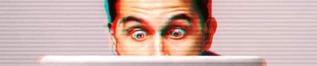 a man looking shocked at his laptop