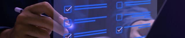 a hand holding a pen checking off a list